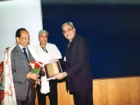 Harsh K. Gupta, Past President (1992-1995) receiving bouquet, memento and citation from the Chief Guest Sailesh Nayak, while P.K. Chadha, Secretary (IGC) helps as felicitator. 
